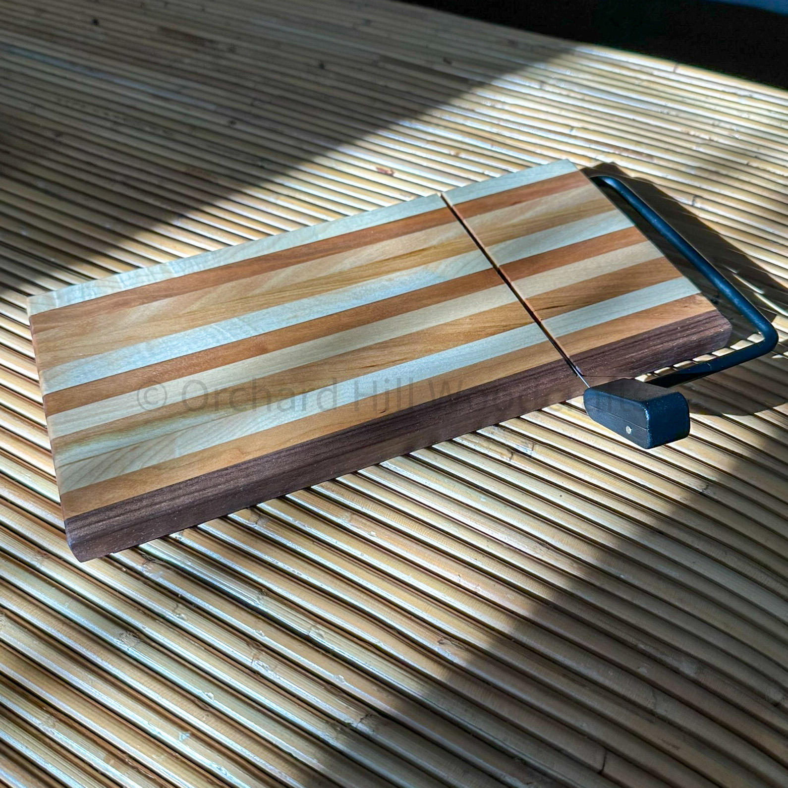 Multi-wood cheese board with wire slicer